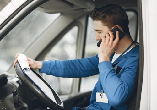 Man in the truck. Guy in a delivery uniform. Man with clipboard.