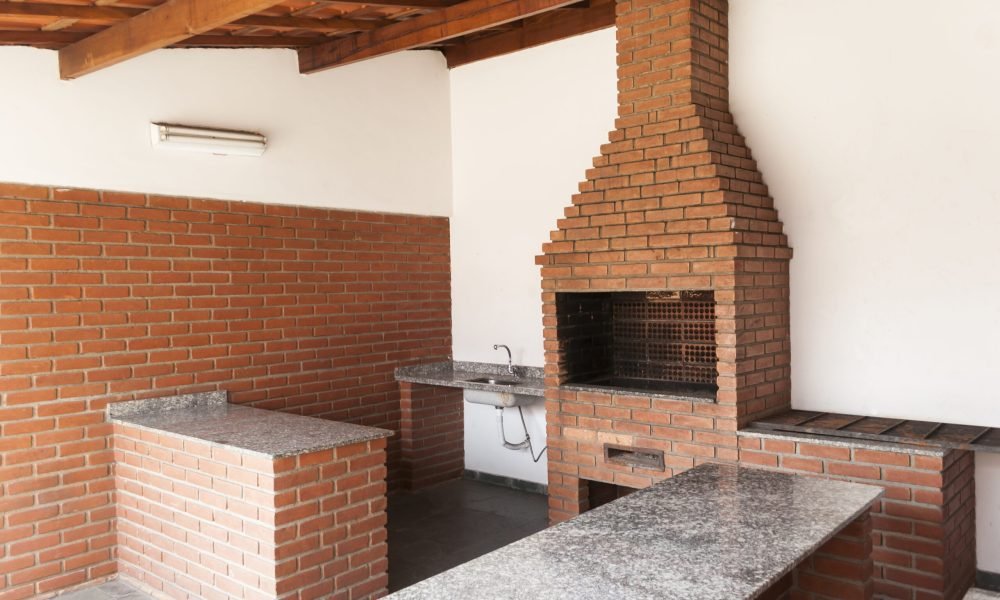 Area with brick barbecue grill and table for celebrations and parties no people.